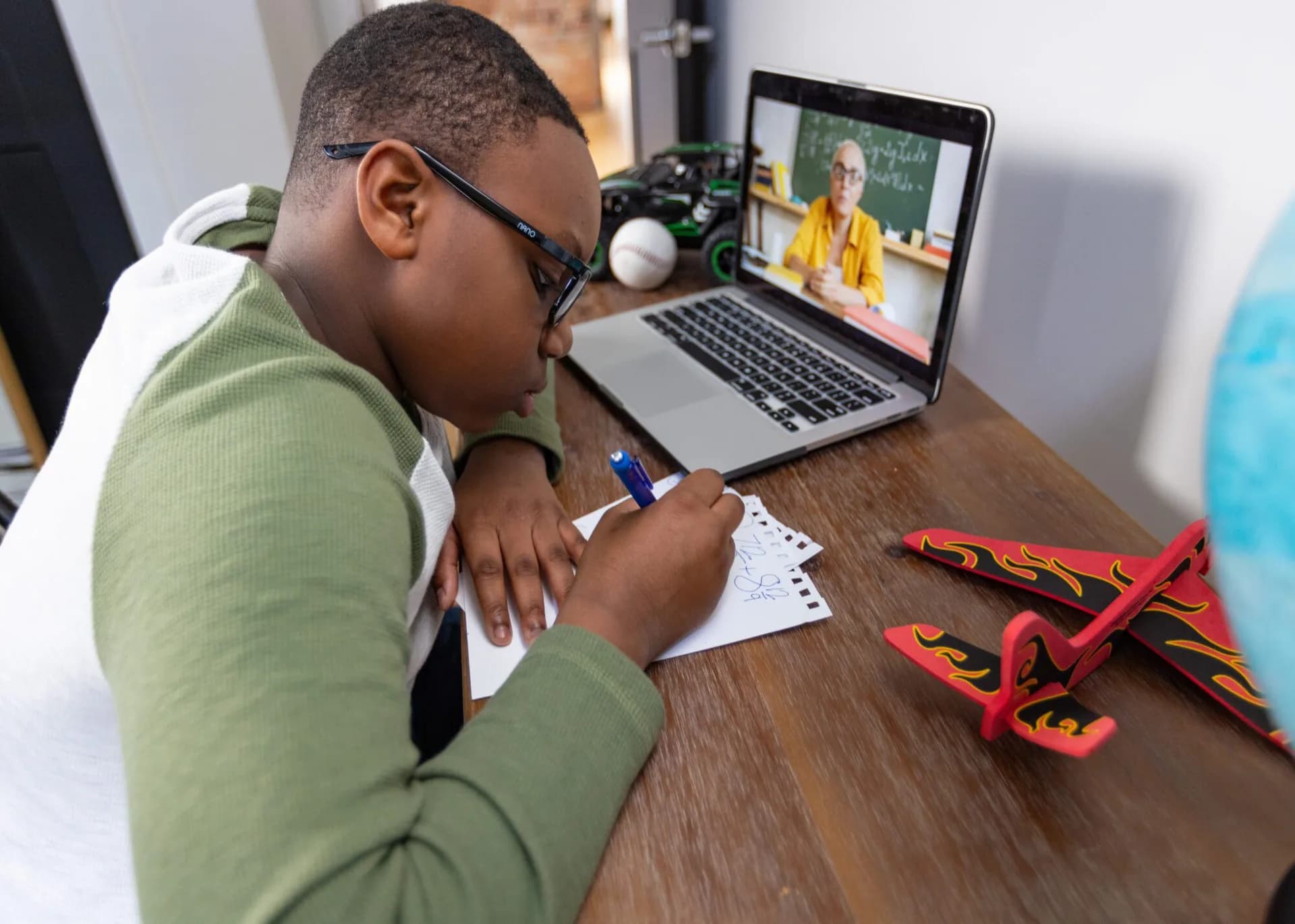 Young boy working on a laptop at his desk